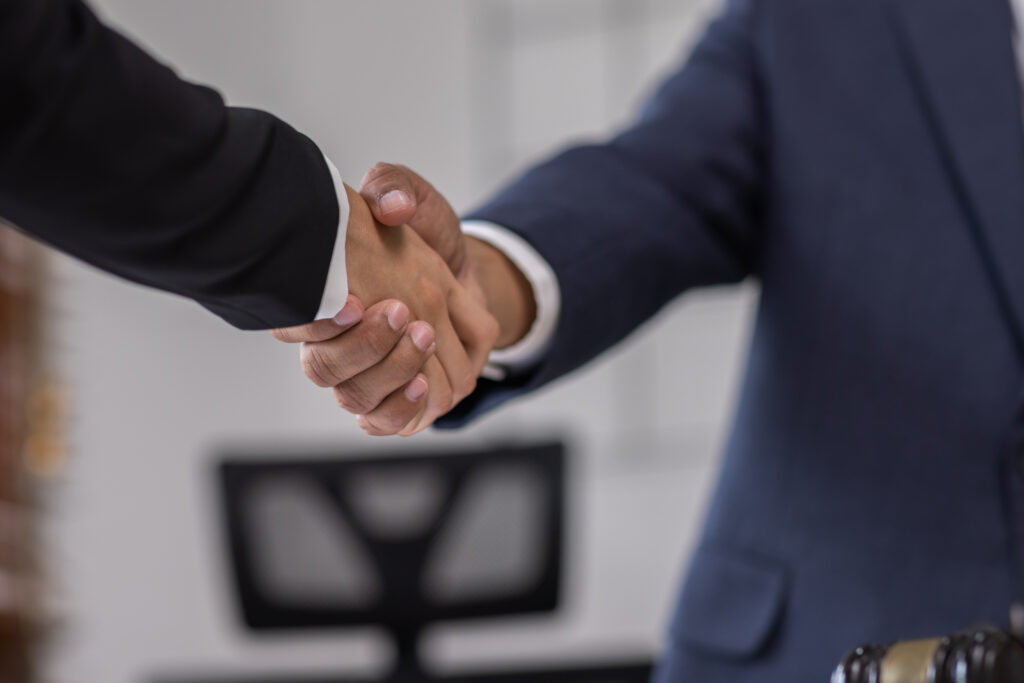 Two people shaking hands in agreement.
