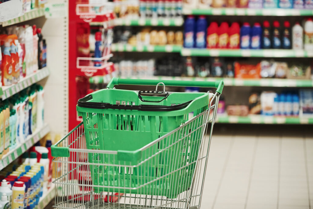 Empty green shopping cart in store