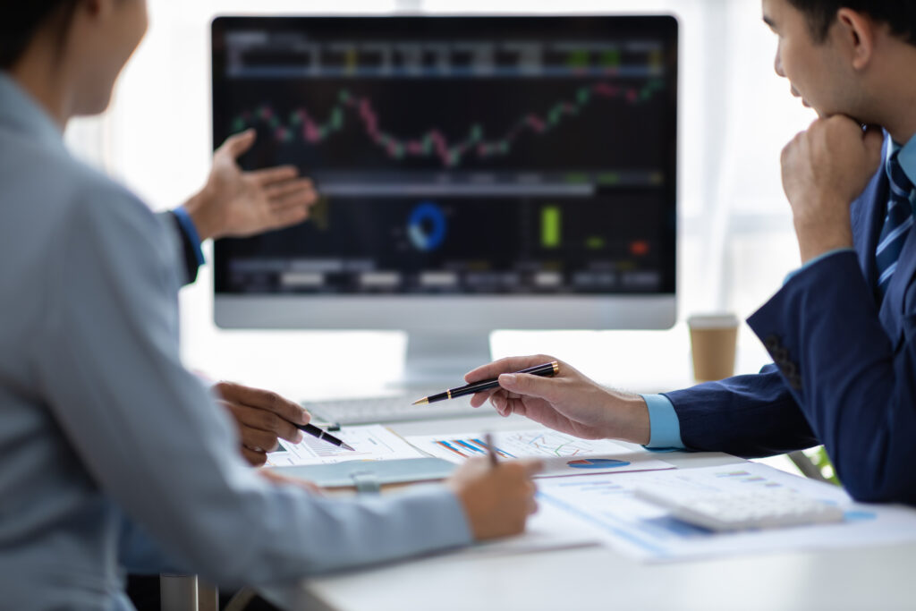 Business meeting with data analysis visuals